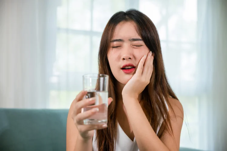 A girl suffering from tooth sensitivity