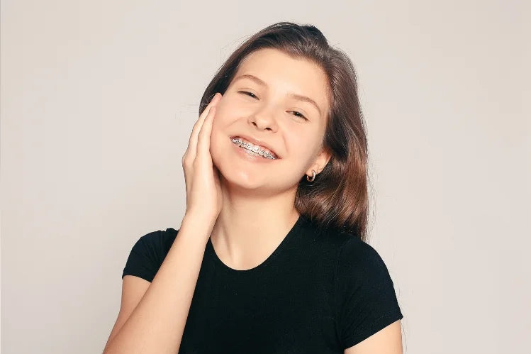 A_girl_smiling_with_metal_braces_on_her_teeth