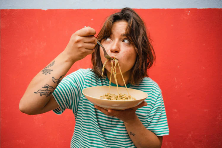 Woman eating pasta on a plate