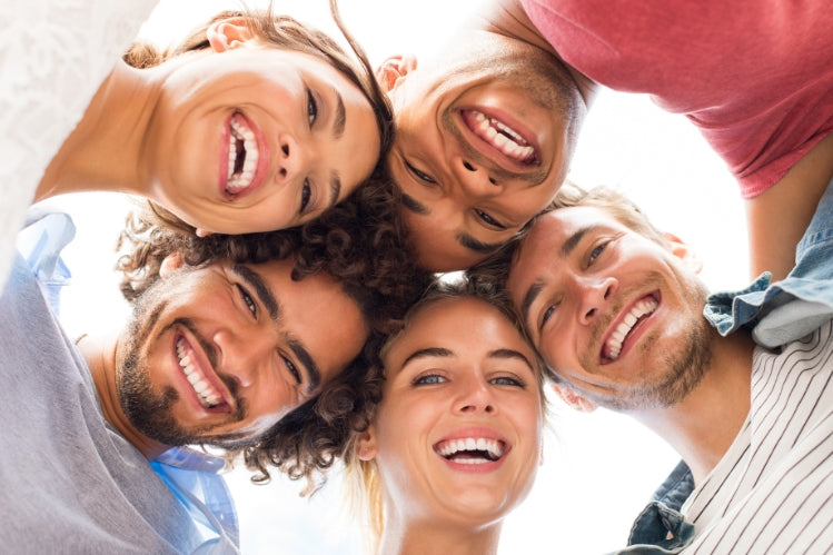 group of friends smiling with straight teeth
